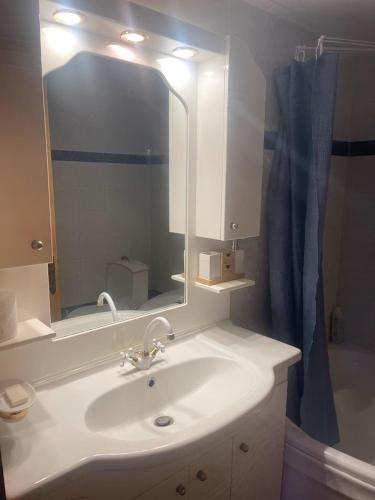 a bathroom with a white sink and a mirror at Valsamo Luxury Cottage in Chaïdeftón