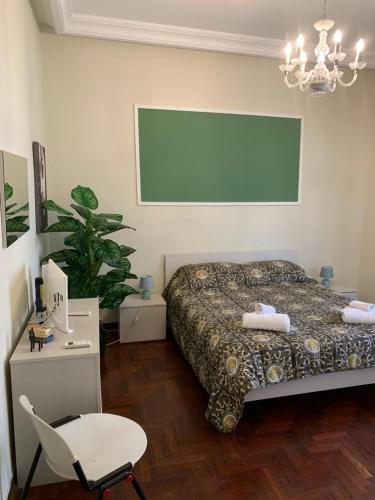 a bedroom with a bed and a chair and a green screen at A Casa di Mau in Palermo