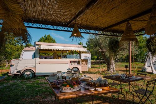 a food truck with a table with food on it at Borgo Del Tempo Ritrovato - Luxury Relais in Puglia in Ostuni