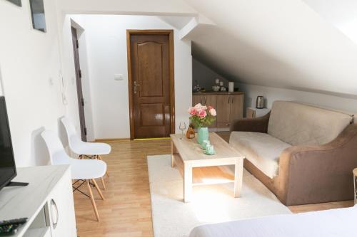 a living room with a couch and a coffee table at APARTMAN MIKI BIJELO POLJE in Bijelo Polje
