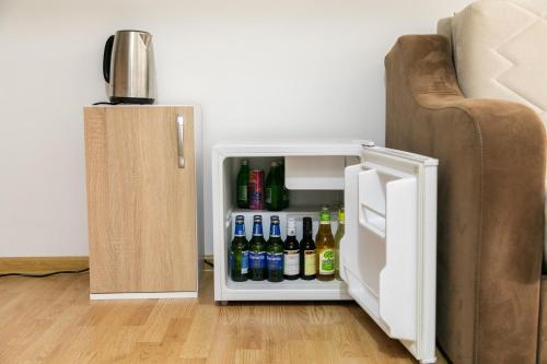 a small refrigerator with drinks in it next to a couch at APARTMAN MIKI BIJELO POLJE in Bijelo Polje
