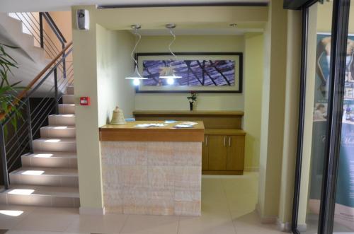 a lobby with a staircase and a television at Apartments Villa Splendor in Vrnjačka Banja