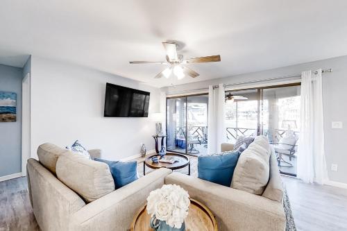 a living room with two couches and a ceiling fan at Turtle Cove 4839 in Kiawah Island