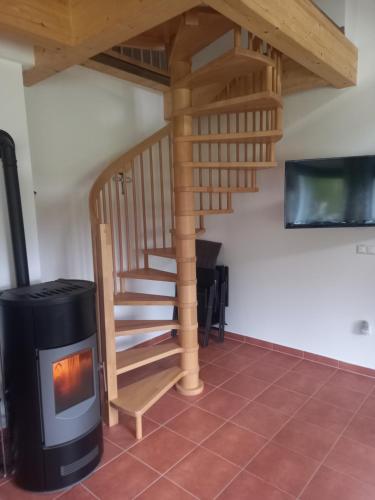 a staircase with a wood stove in a room at Chalet Auszeit in Klöch