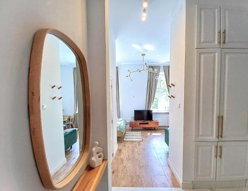 a mirror on a wall next to a hallway at Warsaw Concierge Studio Koszykowa in Warsaw