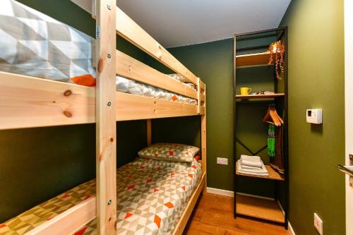 a bedroom with two bunk beds in a room at Dan Y Coed in Pont-Nedd-Fechan