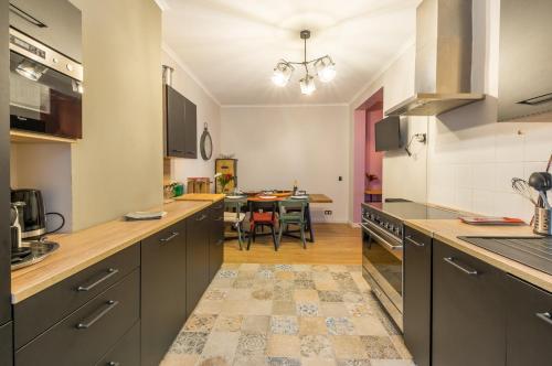 a kitchen with a table and a dining room at L'Authentique - Central - Spacieux - WiFi - Parking Prox in Pézenas