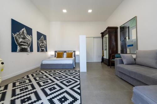 a living room with a couch at Appartamento Via Toledo 55 - Palazzo della Porta in Naples