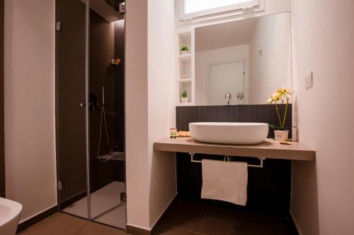 a bathroom with a sink and a mirror at La Corte del Fante in Marsala