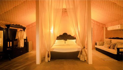two pictures of a bedroom with a bed with curtains at Angirasa Luxury Camping in Hyderabad