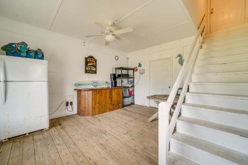 a room with a staircase and a refrigerator at Topsail Beach Vacation Rental Steps to Shore! in Topsail Beach