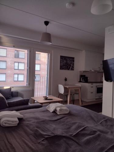a bedroom with a bed and a living room at New apparment near of Airport, in Tikkurila in Vantaa