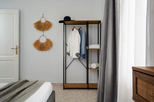 a room with a closet with a coat rack at Erato Inn Naxos in Agios Prokopios