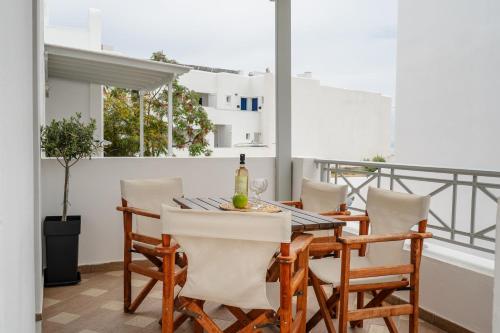 a dining room with a table and chairs on a balcony at Erato Inn Naxos in Agios Prokopios