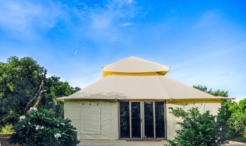 a small white building with a dome on top at Angirasa Luxury Camping in Hyderabad