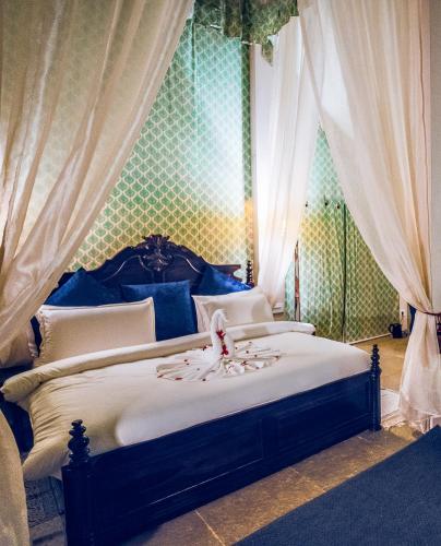 a bedroom with a bed with a blue and green wall at Angirasa Luxury Camping in Hyderabad