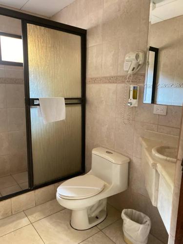 a bathroom with a toilet and a sink at Nacazcol - Playas del Coco in Coco