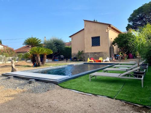 a swimming pool in the yard of a house at Chambre privée in Mandelieu-la-Napoule