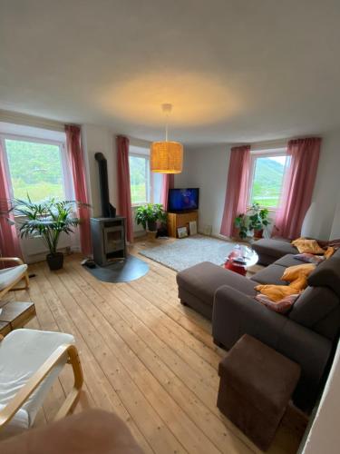 a living room with a couch and a tv at Helles, gemütliches Haus mit Moselblick in Müden