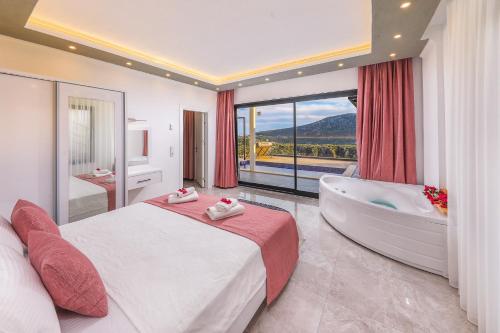 a bedroom with a bed and a bath tub and a window at Villa Likya Honeymoon in Kalkan