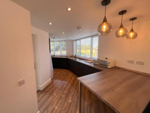 a large kitchen with a counter and a counter top at No 1 Chestnut Grove in Withernsea