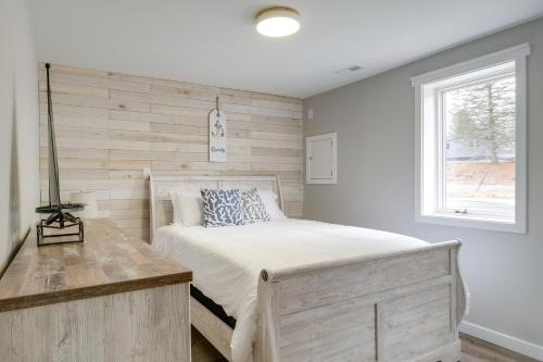 a bedroom with a bed and a window at Modern Traverse City Lake House with Hot Tub! in Traverse City