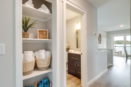 a bathroom with a closet with baskets and a sink at Modern Traverse City Lake House with Hot Tub! in Traverse City