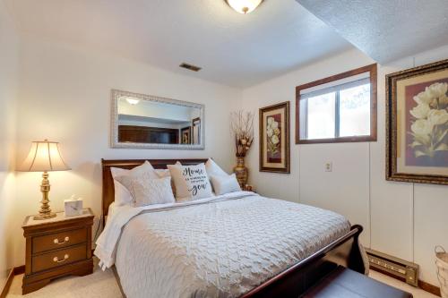 a bedroom with a bed and a window and a mirror at Spokane Valley Vacation Rental with Shared Pool! in Spokane Valley