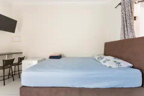 Un pat sau paturi într-o cameră la Pousada Casa da Fernanda, Suíte Family