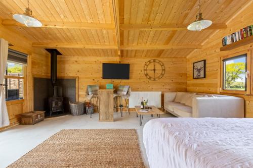a bedroom with a bed and a living room at Nestledstays- Sunbeam in Arundel