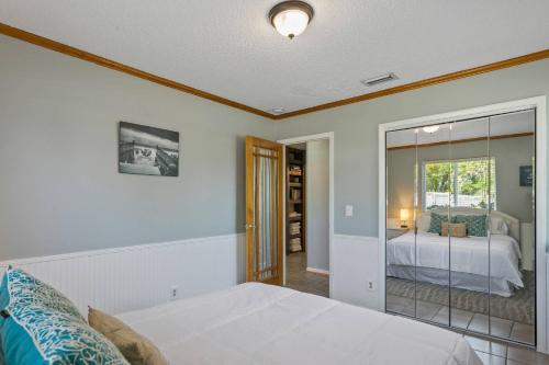 - une chambre avec un lit et un miroir dans l'établissement Beach Bungalow 700, à Jacksonville Beach