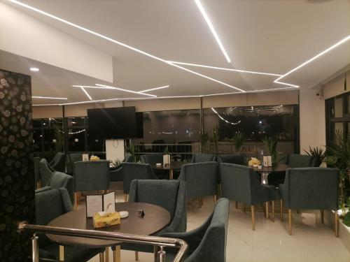 a restaurant with tables and chairs and a television at For Women Only - للنساء فقط in Umm el ‘Amad