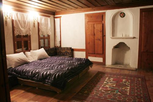 a bedroom with a bed in a room with a rug at Gulevi Safranbolu in Safranbolu