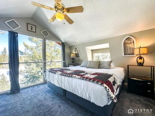 a bedroom with a bed and a ceiling fan at Woodchuck Cabin in Duck Creek Village