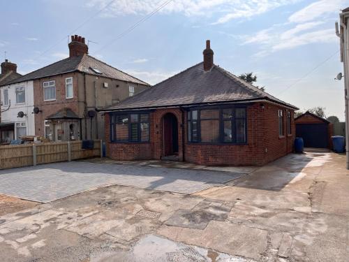 a brick house with a driveway in front of it at No 1 Chestnut Grove in Withernsea