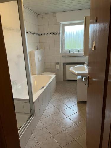 a bathroom with a tub and a sink at Apartment Geronimo in Werne an der Lippe