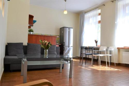 a living room with a couch and a table at Kaletnicza Old Town Apartment in Gdańsk