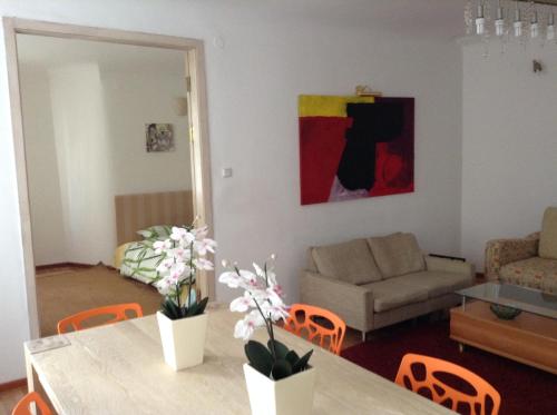 a living room with a table and a couch at Cheap And Chic in Rīga