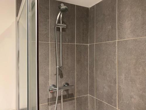 a bathroom with a shower with a glass door at Modern Serviced Apartment - Near City Centre in Doncaster