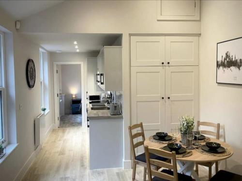 a kitchen and dining room with a table and chairs at Moat View FREE PARKING, CENTRAL, EV PLUG in York