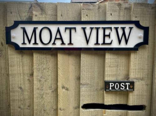 a sign on top of a wooden fence at Moat View FREE PARKING, CENTRAL, EV PLUG in York