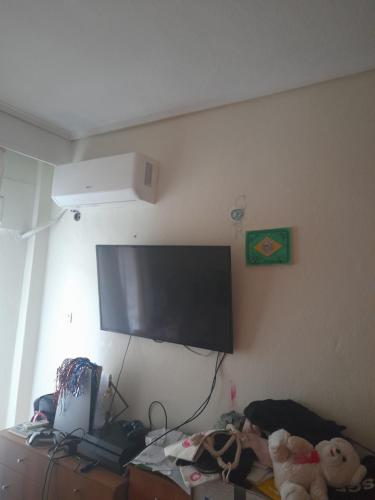 a bedroom with a flat screen tv on the wall at Katerini Paralia in Katerini
