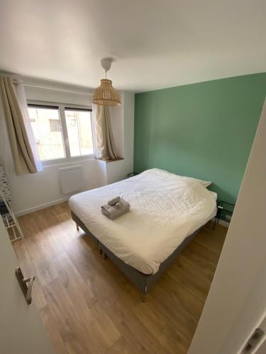 a bedroom with a bed with a towel on it at Le refuge du Touvet in Le Touvet