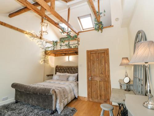 a bedroom with a bed and a ceiling with beams at The Nutshell in Chester-le-Street