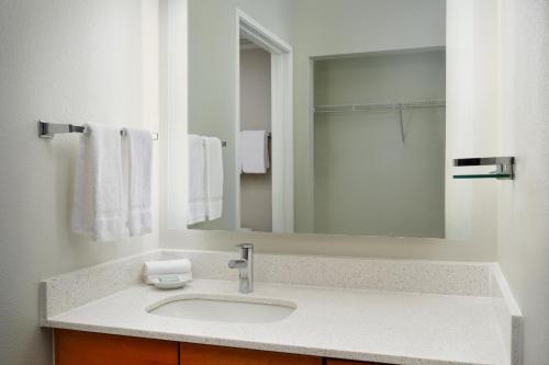 a bathroom with a sink and a mirror at Residence Inn Fort Lauderdale SW/Miramar in Miramar