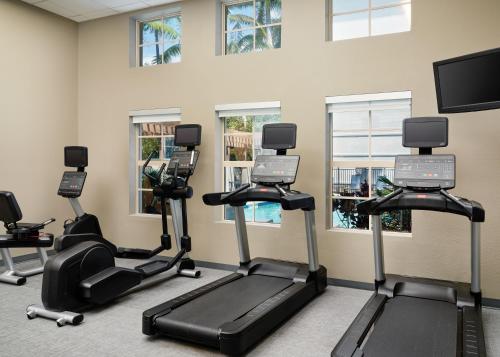 a gym with cardio machines and a flat screen tv at Residence Inn Fort Lauderdale SW/Miramar in Miramar