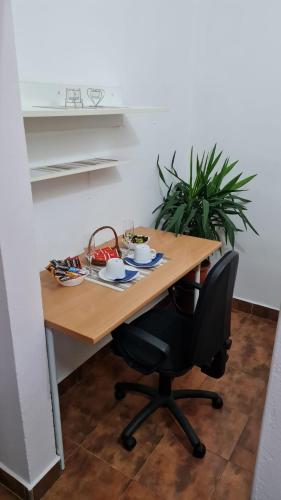 a wooden table with a black chair in a room at Stan Na Dan Kruševac in Kruševac