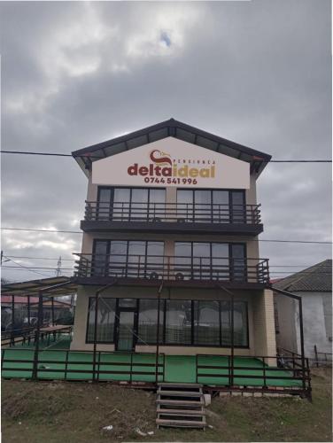 a building with a sign on top of it at pensiunea delta ideal in Sulina