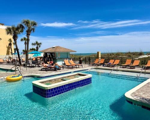 a large swimming pool with chairs and a swimming pool at Best Western Ocean Sands Beach Resort in Myrtle Beach