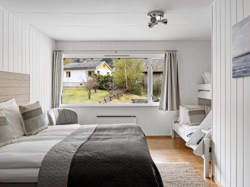 a bedroom with a bed and a large window at Eidfjord Hotel in Eidfjord